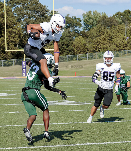 #3 Demetrice Gilbert leaping over the defender for extra yardage on a punt return.