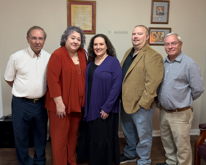 Ownership Change of The McKenzie Banner &mdash; (L to R) Joel and Teresa Washburn sold the company to new owners, Brittany and Jason Martin. Attorney Jeff Washburn, a former co-owner of the publishing company, prepared the legal documents.