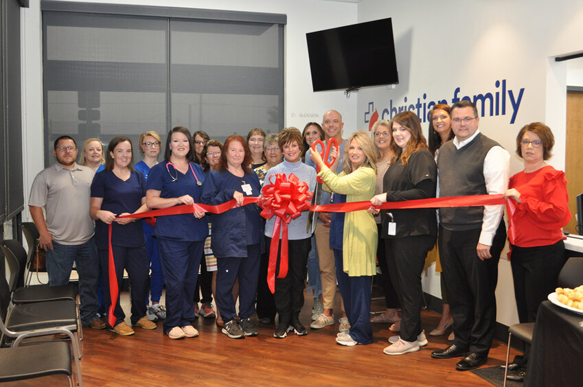 McKENZIE (October 5) &mdash; Members of the community came together for a ribbon cutting at the new facility for Christian Family Medicine and Pediatrics. The facility/group is part of the Fast Pace Urgent Care. Pictured is Donna Waddell, NP cutting the ribbon to the facility at 15015 Highland Drive in McKenzie. Staff holding the ribbon (L to R) are Stacey Kurtz, Bridget Barrett, Jennifer Reynolds, Mimi Cherry (Clinic Director of Trenton/McKenzie/Paris), Waddell, Elaine Boyd and Missy Reeder (in back between Bridget and Jennifer).