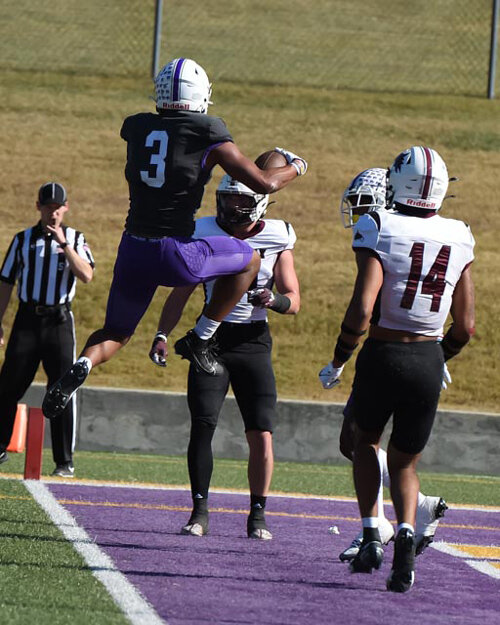 #3 Demetrice Gilbert leaping into the end zone for a TD.