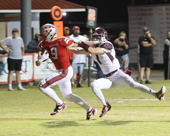 Jake Cassidy (#9) runs after catching a pass for touchdown from Tate Surber.