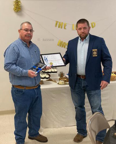 Henry County Sheriff Josh Fry (right) present retiring Henry County Lieutenant Gary Vandiver (left) the Loyal Patriot Award along with his service weapon on Friday.