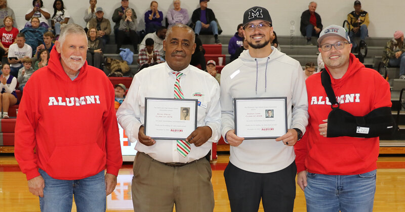 Bryan Rich, Ricky Price, Derek Carr, and Brian Winston during the presentation of honors to Price and Carr as outstanding alumni of McKenzie High School.
