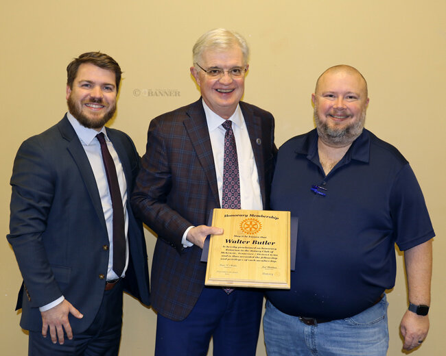 Dr. Walter Butler (center) is joined by his son, Carroll County Mayor Joseph Butler (left), and McKenzie Rotary President Jason R. Martin (right).