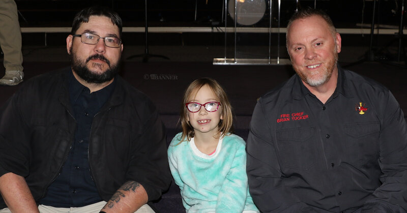 Lillie Atkinson, 7, helped raise $460 through sales and donations at her lemonade stand. She is pictured with McKenzie Police Chief Ryan White (left) and McKenzie Fire Chief Brian Tucker.