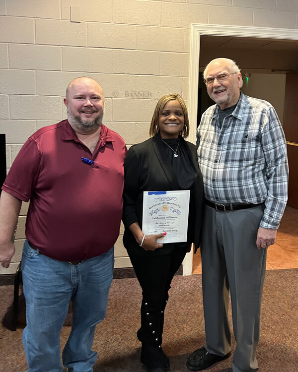 Rotary President Jason R. Martin (left) and Rev. Dr. Ed Perkins (right) welcomed LaShonda Williams (center) to the McKenzie Rotary Club.