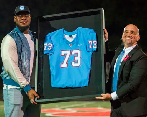 USJ alum and Kansas City Chief Trey Smith and Head of School Don Roe hold up Smith’s retired jersey during the University School of Jackson vs Evangelical Christian School TSSAA Football match in Jackson, Tenn. on Friday, October 13, 2023.