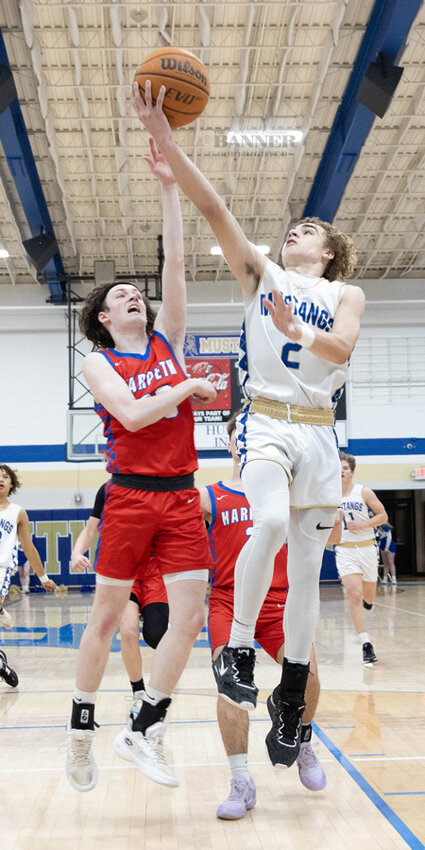 Mustang Caleb Ezell jumps past Harpeth Hills for another basket.