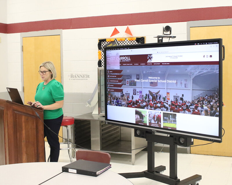 Michelle Robinson demonstrates the new website and mobile app to the Board of Education members.