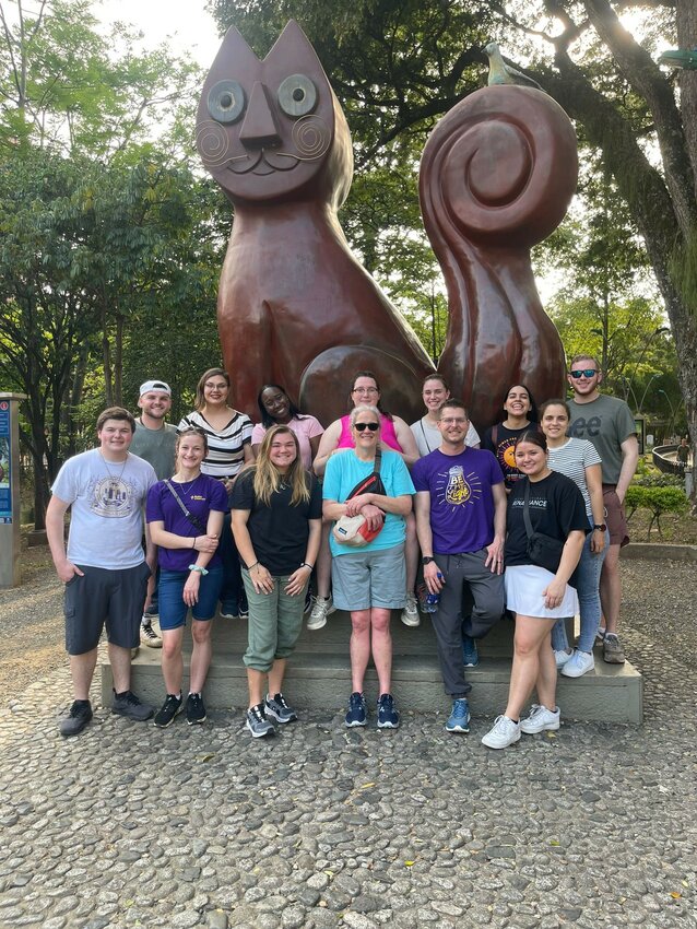 After time in the classroom interacting with students of all ages as native English speakers, volunteers from Bethel University and Global Citizen Adventure Corps toured areas of Cali, Colombia. They are seen here in Parque del Gato (Park of the Cat). Back row from left to right are Jacob Ervin, Brandi George, a teacher from Colegio Americano, Charli Rice, Jessica Burns, two more teachers, and Carson Stover. Front row from left to right are Trevor Scott, Koryn Fenty, Sydney Moyer, Christa Rice, Garrett Burns, and Mercedes Wright.