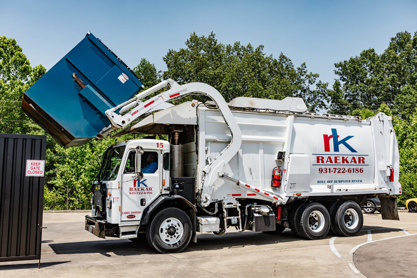 RaeKar provides commercial and residential trash pickup services. Pictured is a waste collection truck.