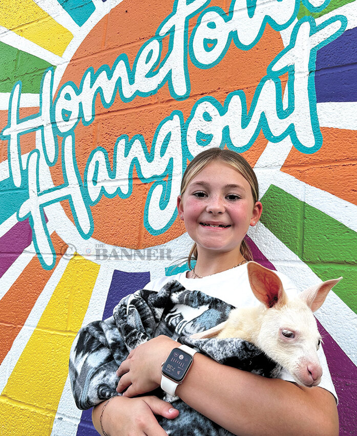 Natalie Gurley holds the 7-month-old albino kangaroo during an event at Hometown Hangout.