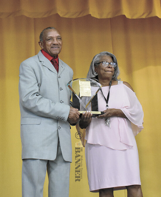 Outgoing National President Neal Williamson was presented a plaque commemorating his service during the fashion show. He and wife Priscilla were recognized on stage and honored at length by the large audience.