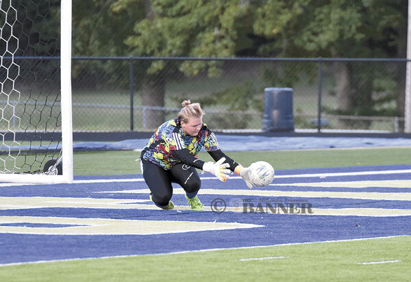 Huntingdon goalkeeper Maddie Brinkman dives for one of her 23 saves in the match.