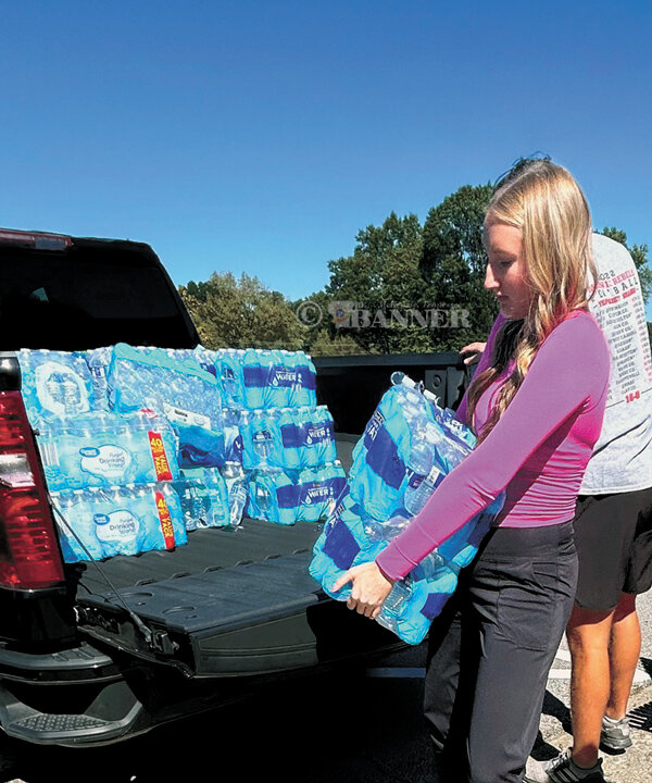 Sophie Pate of McKenzie High School unloads cases of water at the TCAT-McKenzie.