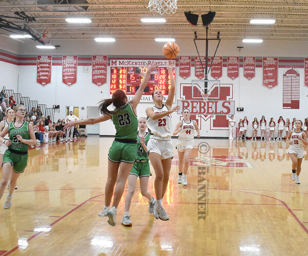 Lady Rebel Jaycee Stafford floats a shot over a Houston County defender. Stafford led all scorers with 31 points.