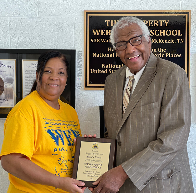 Kim Bell Webb presents a plaque to Charlie Scates, former educator at Webb School.
