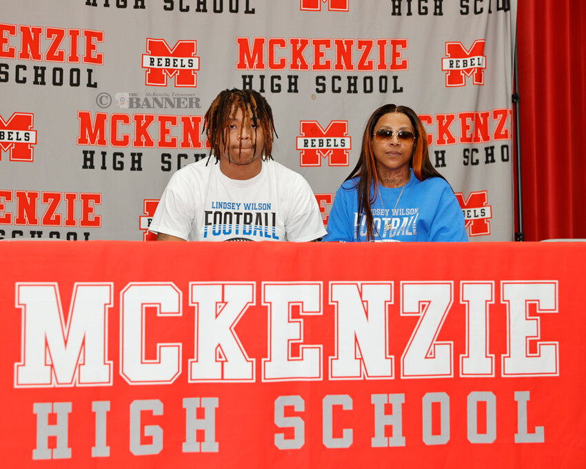 Martez Teague signs with Lindsey Wilson College to play football. He is pictured with his mom, Dominic Teague.