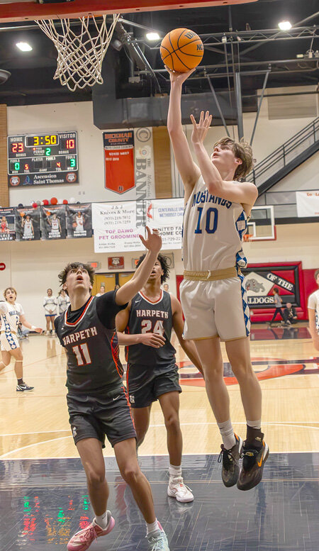 Mustang EJ Lewis goes to the rim for two points.