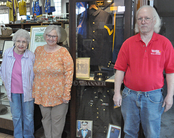 From (L to R): Nola Hobbs, vice president of the Carroll County Historical Society; Jennifer Waldrup, great-granddaughter of Cpl. Stewart Huffman; and Brent Cox, director of the Gordon Browning Museum, with the new uniform display.