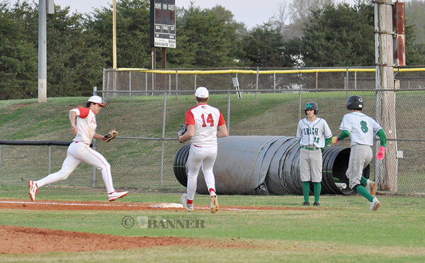 Rebel first baseman Tate Surber fields a grounder and wins the footrace to first base for the out.