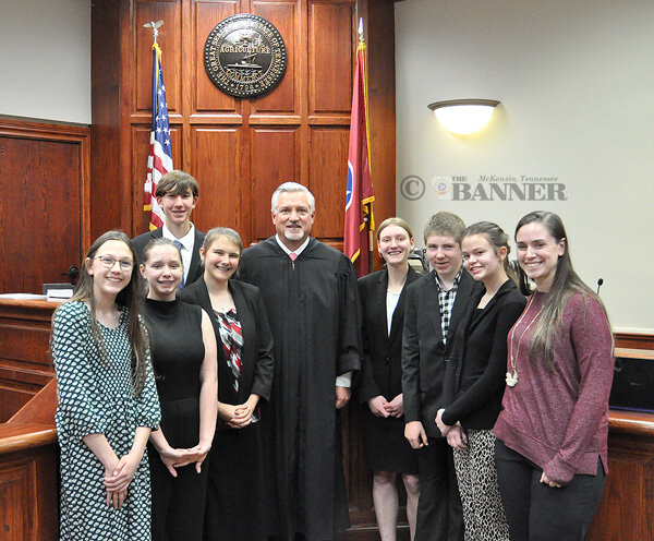 The Jackson Classical Conversations Challenge B community was one of three teams of homeschool students to participate in mock trials at the Carroll County Courthouse. Pictured are (L to R): Avonlea Banks, Katheryn Burns (of McKenzie), Ezra Pond, Marie Hoover, Judge Brent Bradberry, Elyse Voorhis, Levi Dahl, Nora Reini and Jessica Burns (of McKenzie, director of the Jackson Challenge B community.