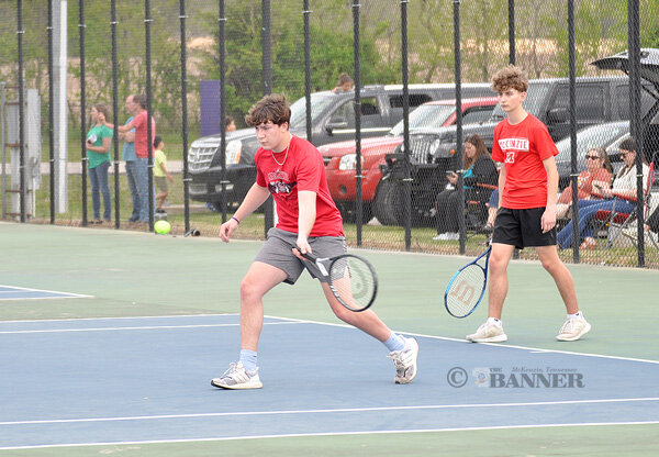 Rebel Owen Walker returns a volley in doubles play with partner Alex Garcia.
