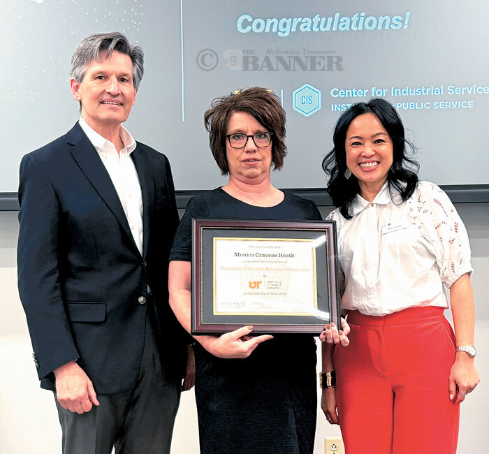 Monica Heath receives her certificate from CIS Executive Director Paul Jennings and TCED Program Director Tintin Czach.