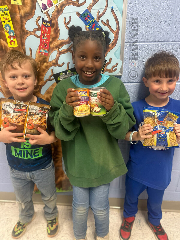 First graders (L to R) Kenson Keymon, Livaeh Harrell and Lucas Edwards showing some of the donated items.