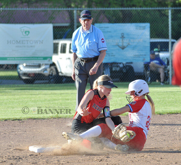 Lady Rebel second baseman Kailie Hudgins applies the tag and hangs on through the collision for the out.