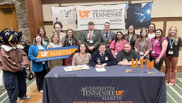 GATLINBURG (March 25) &mdash; McKenzie High School senior Nathan Lease signed a letter of intent to join the Agricultural Education program at the University of Tennessee at Martin during TeachAg Signing Day at the State FFA Convention. Lease is the president of the MHS FFA Chapter and the son of Magan and Justin Lease. Pictured seated are (L to R): MHS FFA sponsor Lindsey Parham, Lease and his father.