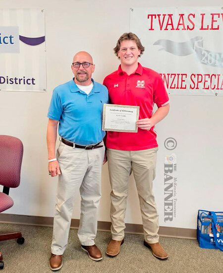 Board member Bobby Young (left) presents a certificate to Ryan Toombs, who attended the SCOPE conference in March. Fellow SCOPE participant Carli Beeler was unable to attend the meeting.