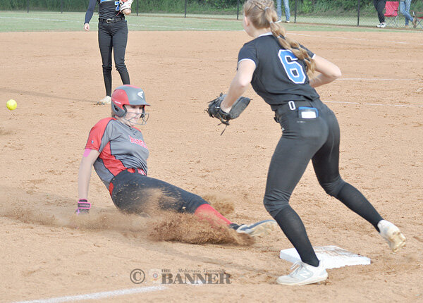Lady Rebel Braylin Auvenshine slides into third ahead of the throw.
