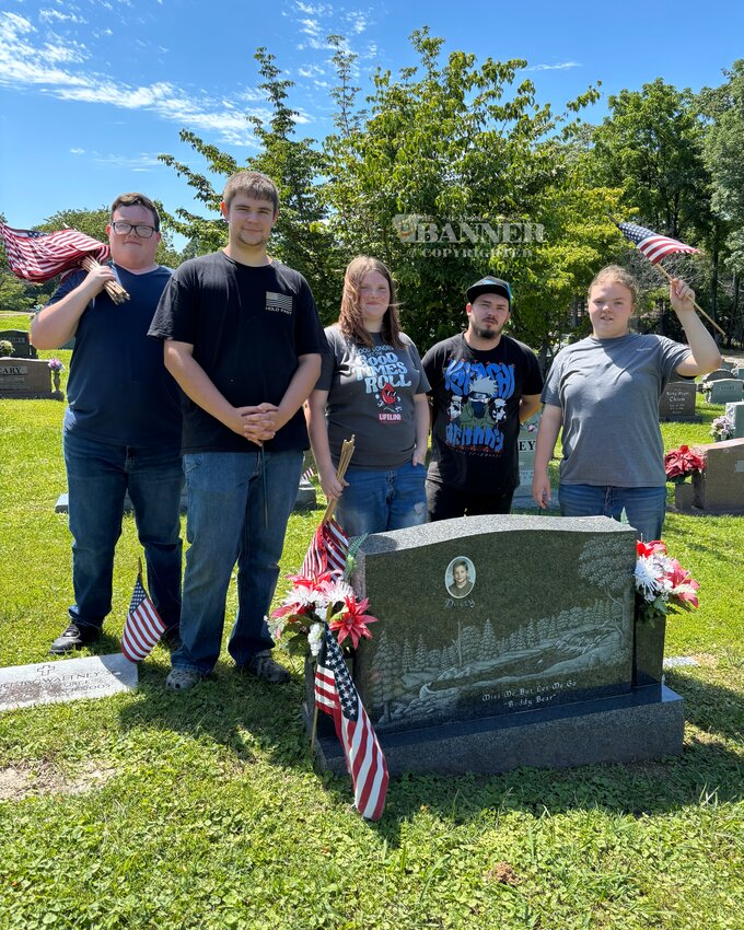 (L to R) Dalton McKinney, Jack Hardwick, Taylor Gulledge, Chris Luci and Kylie Gulledge assisted Dana and Tan-Gee Deem, both Air Force veterans, place flags at Carroll Memorial Gardens.