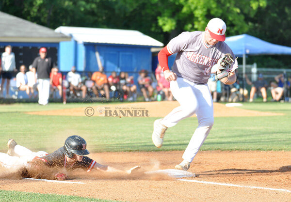Rebel pitcher Craegen Travis just beats a sliding Bradford base runner to first for the out.