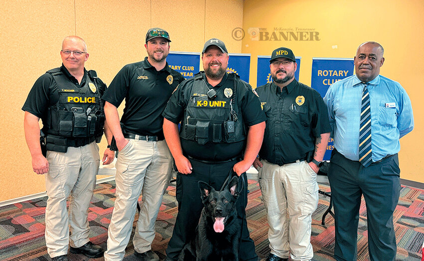 MPD Assistant Chief Trey Boucher, Investigator Justin Brister, Sergeant Cody Coleman with canine Toby, and Rotary Vice-President Ricky Price.