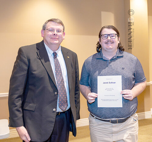 Jacob Sullivan (right), a senior mass media and strategic communication major from Huntingdon, receives the West Tennessee PBS Scholarship from Rodney Freed, instructor of mass media and strategic communication.
