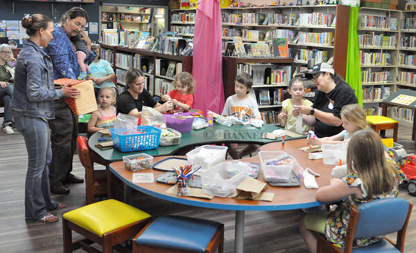 Kids show off their puppets after the puppet show. Pictured are (L to R) Front Row: Zachary Watwood, Kash Keech, Kali Keech and Sophie Whitt. Back Row: Head Start family specialist Crystal Fuller, Head Start family services worker Karen Teem and children’s librarian Grace Hawkins.
