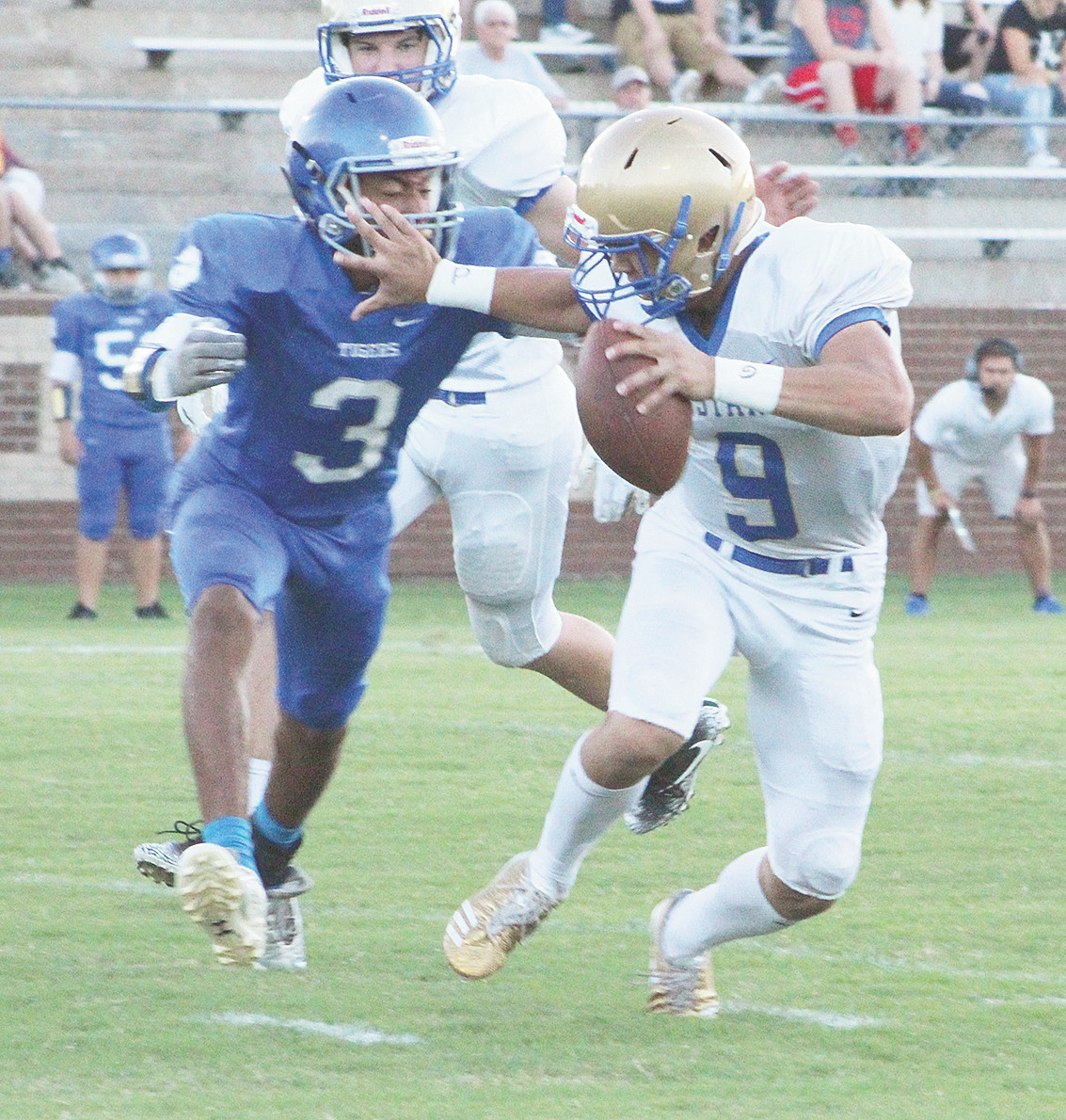 Hunter Ensley stiff arms Bruceton’s Cameron Hudson on a keeper.