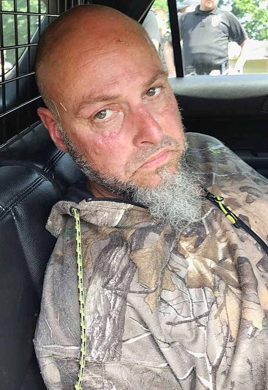 Curtis Ray Watson, 44, after he was captured and placed in a patrol car. He suffered from bug and tick bites and problems with his feet from being wet. He previously resided in Huntingdon.