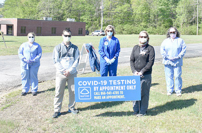 From left, Baptist-Carroll County employees Jessica Painter, LPN; Rob Eldredge, ATC; Cindy Cole, RN; Sheilla Deaton, PTA; and Tina Simpson, CST help run the site, organizing procedures, directing patients and supervising and ensuring safety protocols.