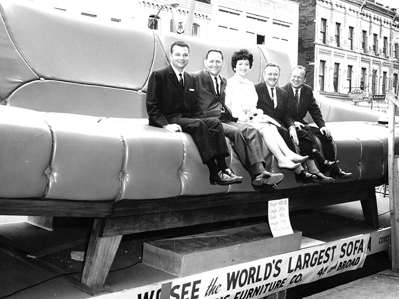 World’s largest sofa manufactured by Gaines Manufacturing Company, early 1960s. Ben and Ludie Gaines are pictured second and third from left.