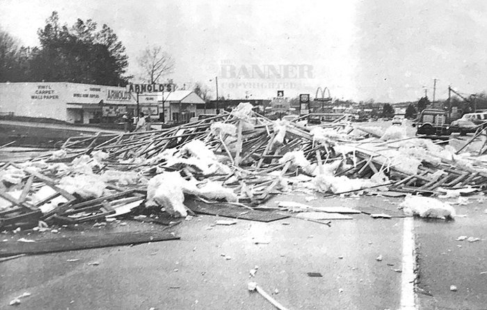 The splintered remains of Tommy’s Carpet stretches across Highway 79 in McKenzie shortly after it was struck by a tornado.