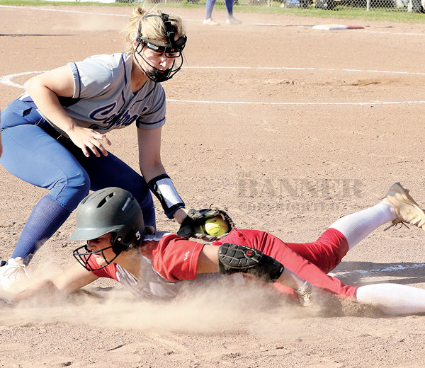 Lady Rebel Katie Chesser is safe after beating a tag by Bruceton third baseman Carlee Hicks. Hicks was injured late in the game and was transported by ambulance from the field. Her coach said she is doing well.
