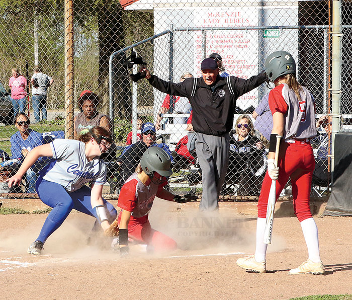Lady Rebel Anna Robinson beats the tag after stealing home against Bruceton. Pitcher Addison Hampton attempts the tag.