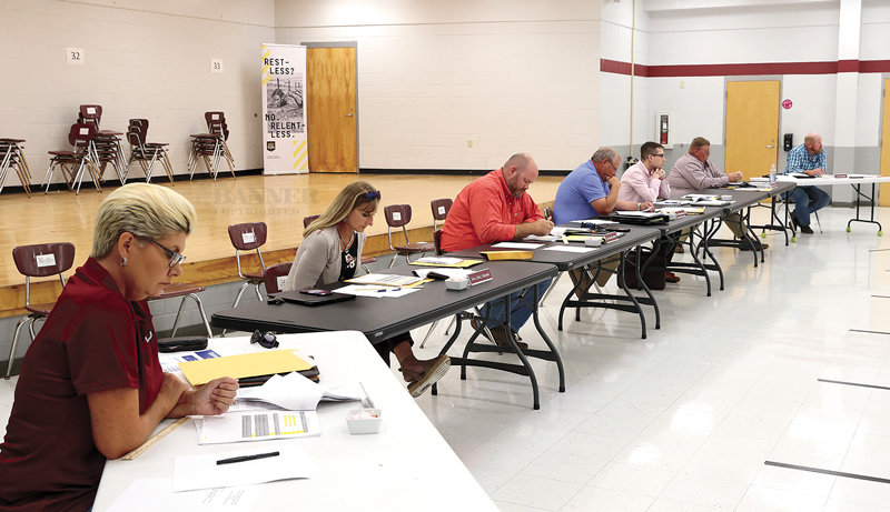 West Carroll School Board reviews the 2021-22 budget before passage. Pictured (L to R) Kimberly Smith, Misty Mitchell, Jeremy Jackson, William Robinson, Christopher Hayden (attorney), Patrick Lindsey and David Hilliard.