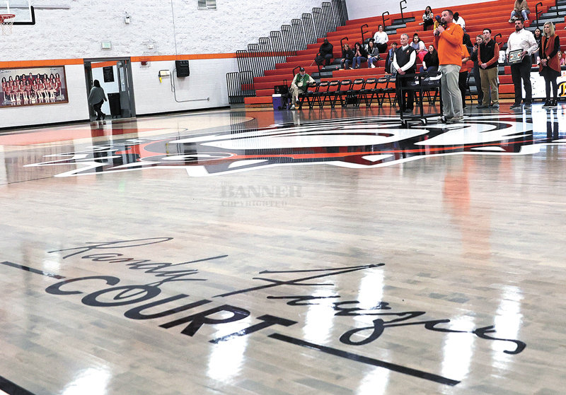 The imprint on the court bears the name of Randy Frazier. Gleason Principal Lee Lawrence announces the accomplishments of Mr. Frazier as the former coach and his family stand facing the home audience.