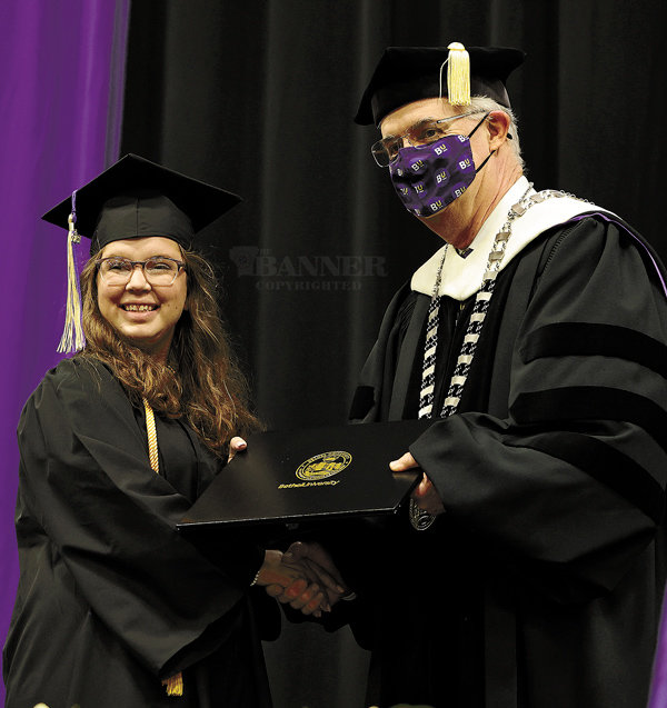 Devyn Smiley receives her diploma from Dr. Walter Butler.
