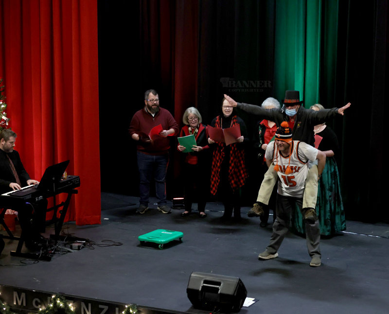 Mark Warren and Ed Long perform a hilarious version of “The 12 Days of Christmas,” accompanied by The Mistletoe Singers.