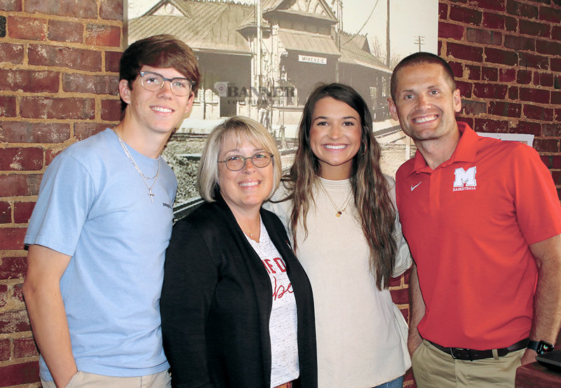Pictured are Zayden McCaslin, Rotary President Sandi Roditis, Dani Dyer and Head Coach John Wilkins.